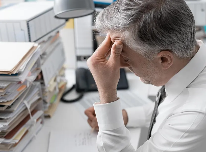Business owner overwhelmed by accounting paperwork